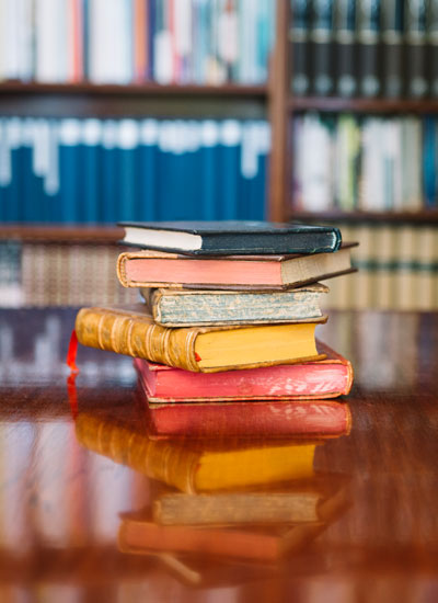 nebb-bookstore-stack-of-books-on-wooden-table