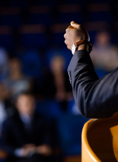 nebb-annual-conference-obscued-man-speaking-to-crowd