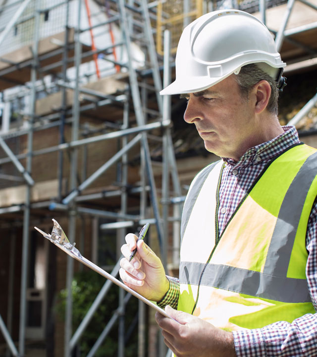 man-in-white-hard-hat-wearing-reflective-vest-holding-clipboard-nebb-instrument-requirements