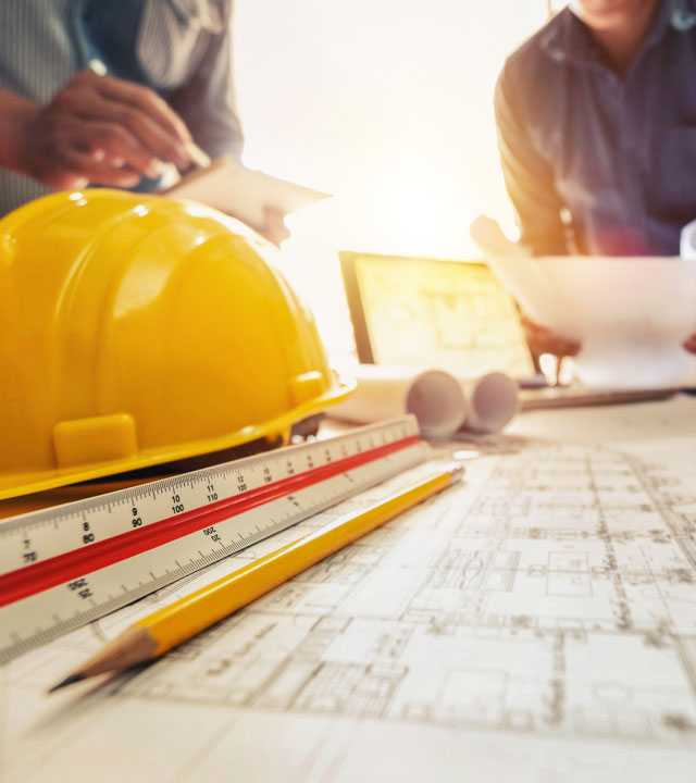 yellow-hard-hat-and-pencil-on-table-with-building-plans-nebb-continuing-education-credits